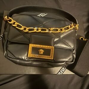 Elegant Black Leather Versace Puffer Bag with Gold Accents